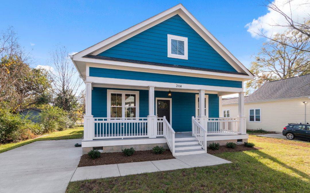 A Blue House With White Trim And A Porch - Aluminum Siding