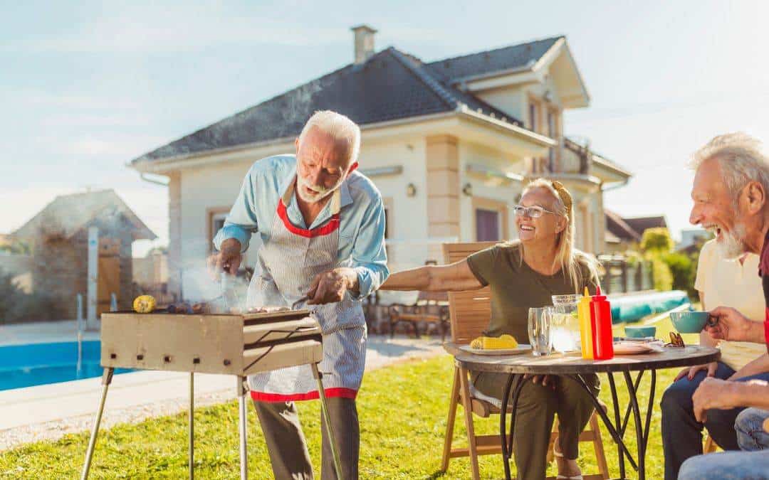 A group of people sitting around a bbq grill - maintenance-free-gutter-guards-provide-high-ROI